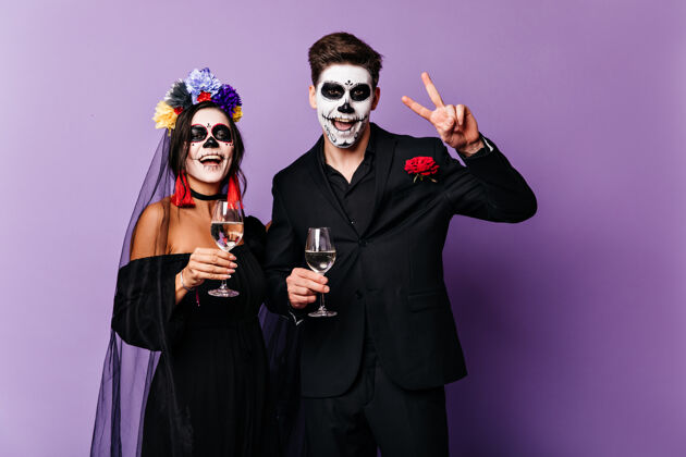酒快乐的男朋友和女朋友喝香槟 庆祝万圣节的形象 墨西哥式的新娘和新郎女人玫瑰浪漫