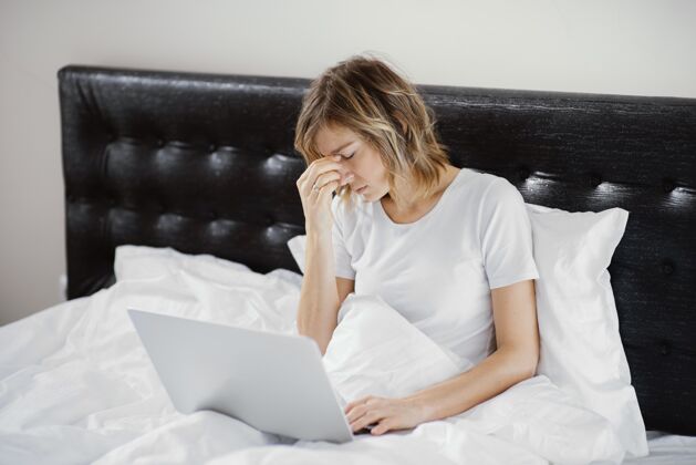 卧室女人在床上用笔记本电脑设备上瘾科技