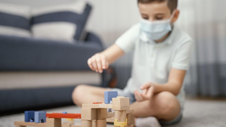 流感呆在家里玩玩具的孩子待在家里面罩预防