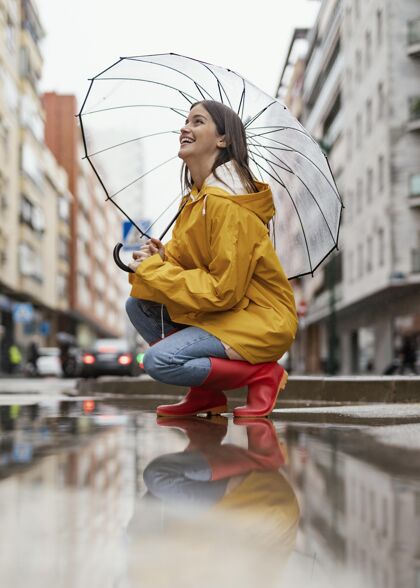 表情带伞的女人站在雨中侧视女性五颜六色发型