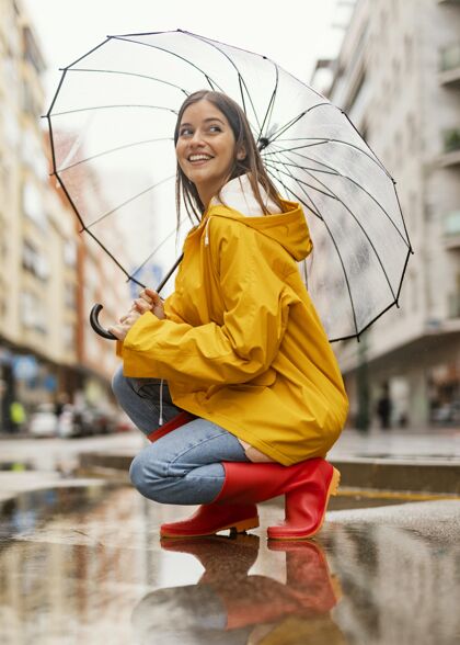 人类带伞的女人站在雨中侧视学生女性美女