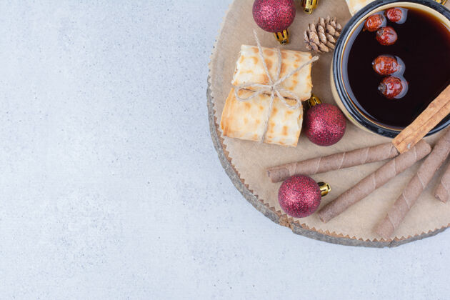 杯子一杯茶 上面放着玫瑰果 饼干和小装饰品饼干茶圣诞节