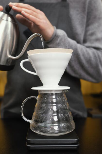 专业男咖啡师在咖啡过滤器里倒水咖啡师服务员职业
