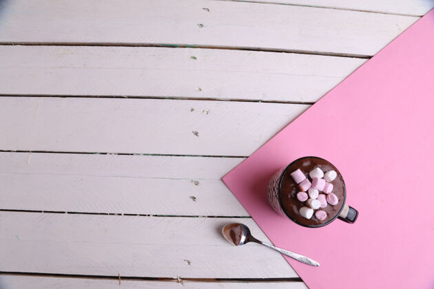 巧克力一杯热巧克力加棉花糖和一个勺子放在餐桌上的俯视镜头饮料糖糖果