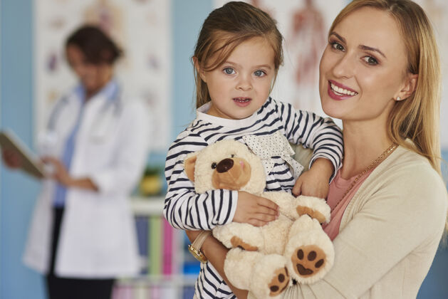 医院勇敢的小病人拿着她的玩具亲子关系儿童女儿