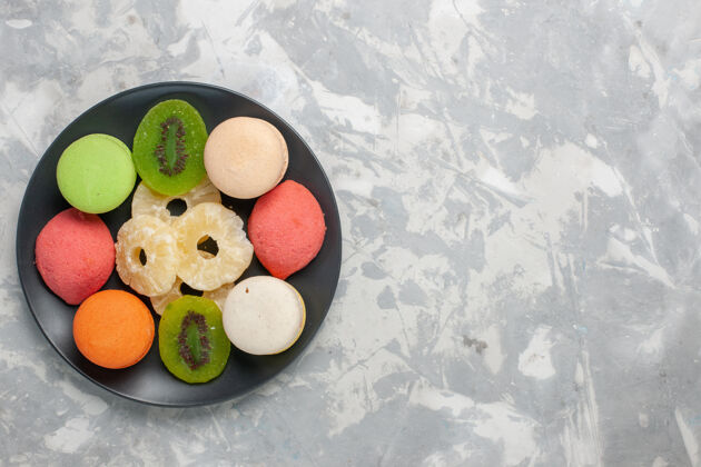 菠萝顶视图彩色小蛋糕与干菠萝环在浅白色的表面顶部食物新鲜
