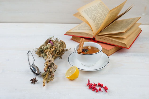 杯子特写的草药茶和柠檬花 滤茶器和香料玫瑰花瓣过滤器