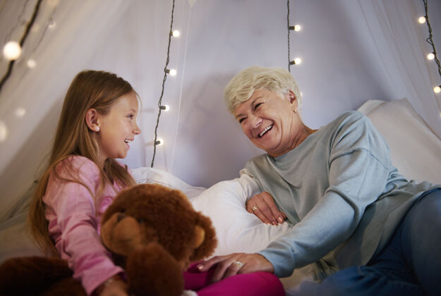 庆祝奶奶和孙女在卧室里玩乐趣泰迪结合