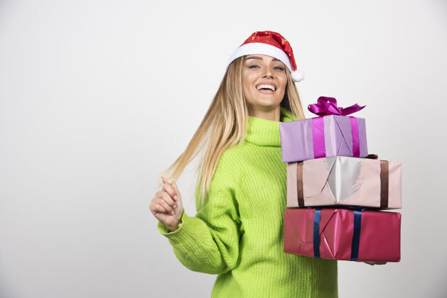 礼品盒年轻微笑的女人手里拿着圣诞礼物礼物女性圣诞快乐