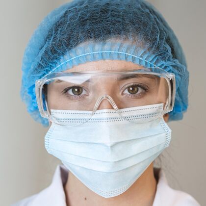 正方形戴着安全眼镜 发网和医用面罩的女科学家的正面图科学研究网络