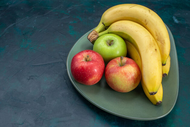 景观前视不同的水果组成苹果和香蕉上深蓝色的桌上水果新鲜醇厚的异国情调热带苹果可食用农产品