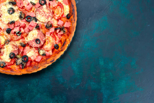 快餐俯瞰图蓝色背景上烤着美味的披萨 配上橄榄香肠和奶酪烘焙胡椒顶部
