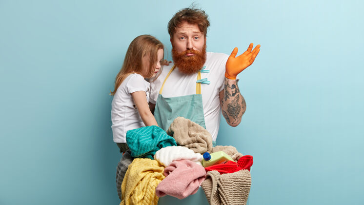 年轻人姜黄胡子男人抱着女儿洗衣服摆姿势毛巾人